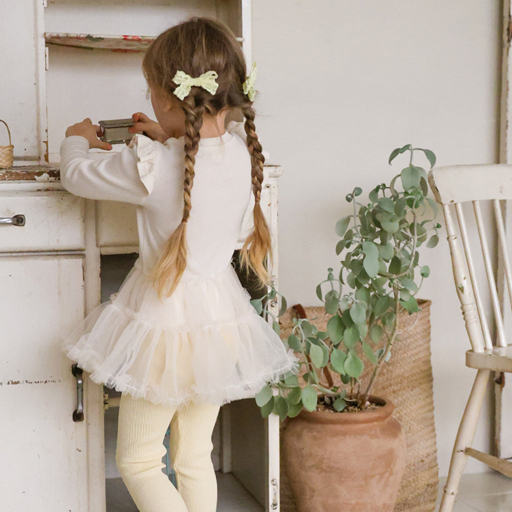 Child wearing Puella Flo Lou Bow Hair Clip in Yellow