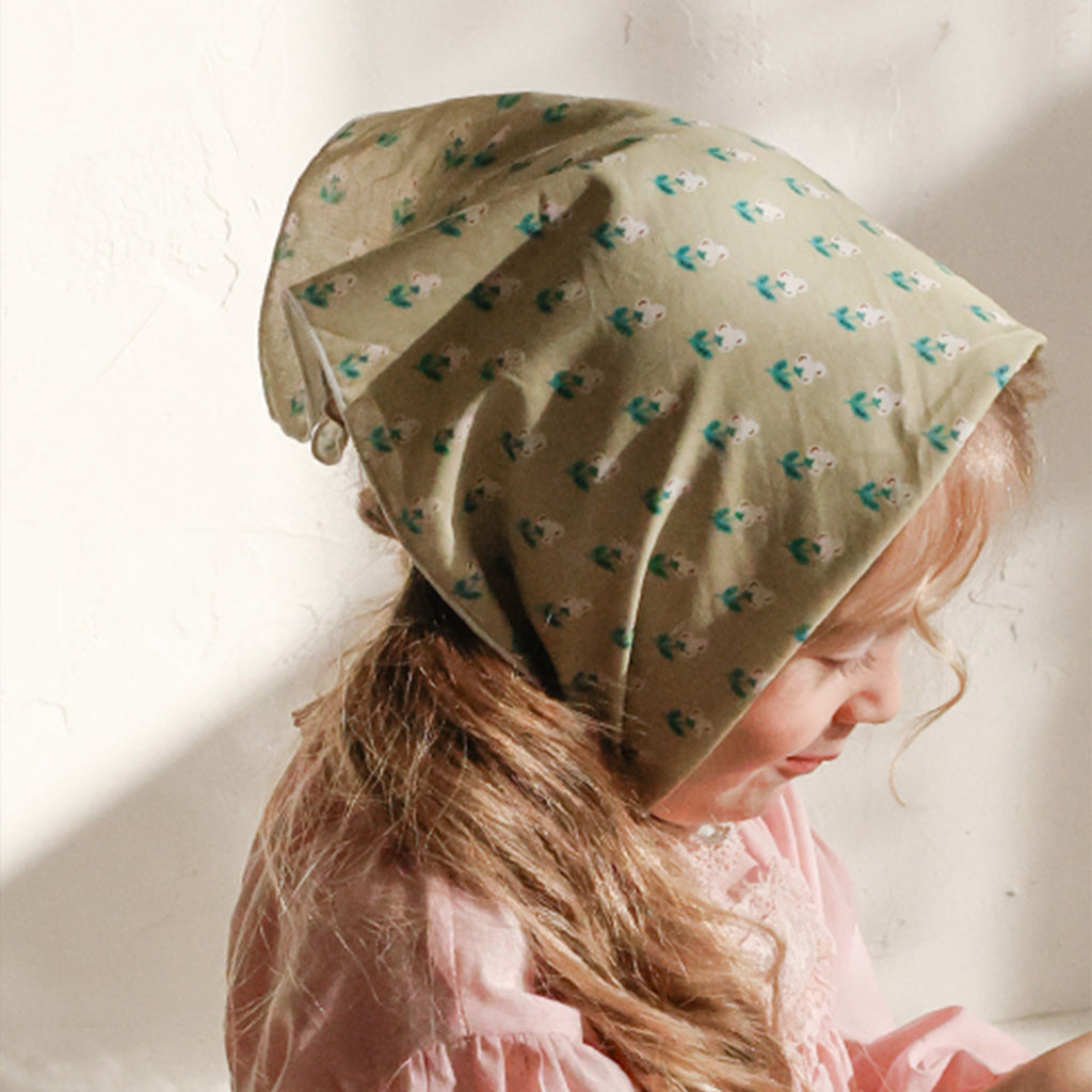 Child wearing Puella Flo Arona Scarf Pattern C in Green