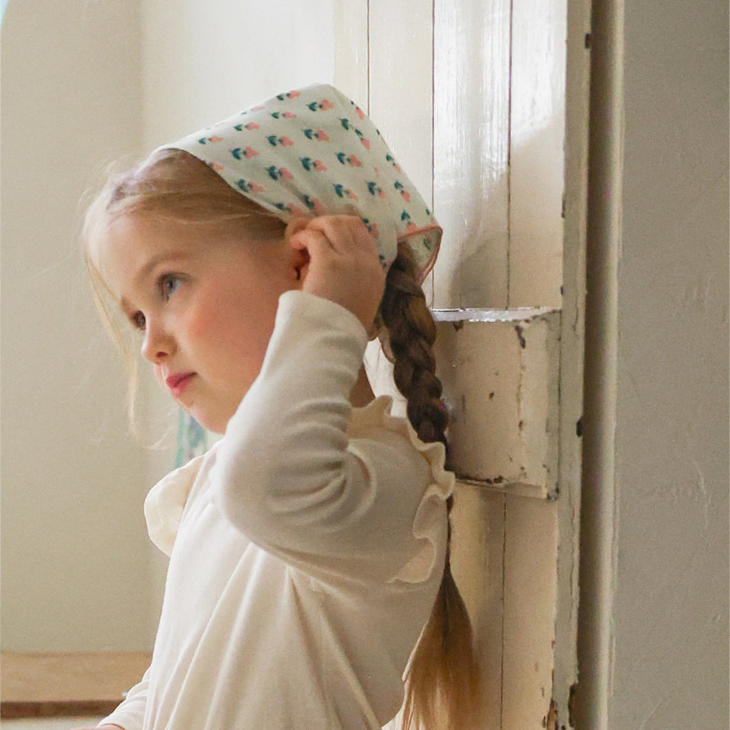 Child wearing Puella Flo Arona Scarf Pattern C in Ivory