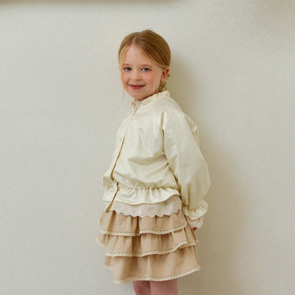 Child wearing ROA Ruffle Trim Windbreaker Jacket in Cream