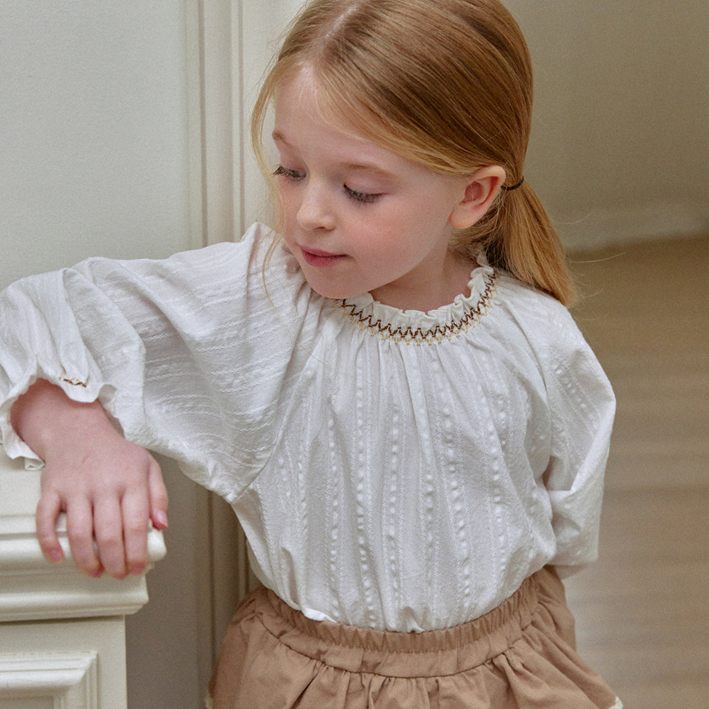 Child wearing ROA Smocked Floral Print Blouse in Ivory