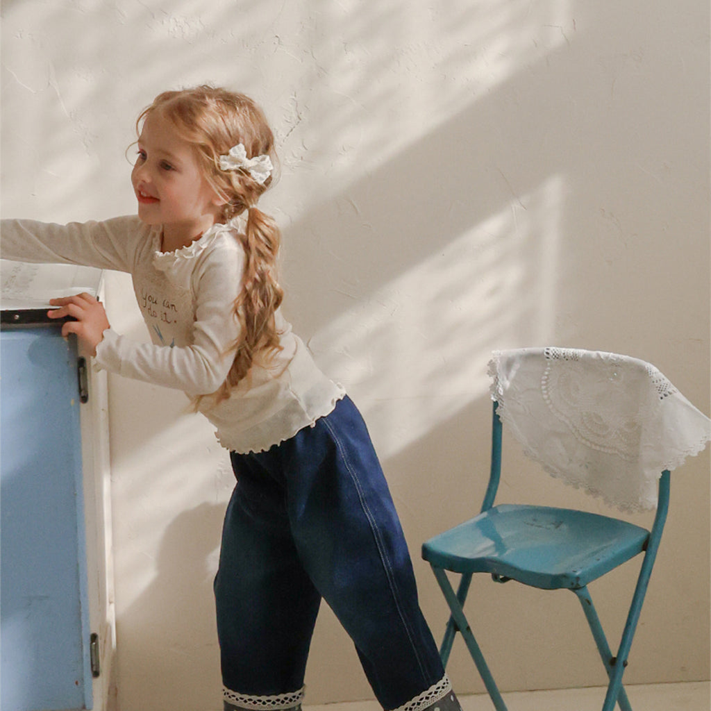 Child wearing Puella Flo Lou Bow Hair Clip in Ivory