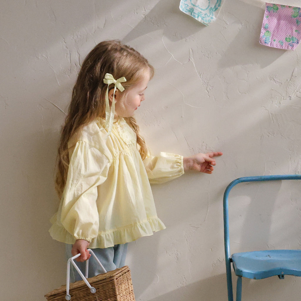 Child wearing Puella Flo Jen Floral Hair Pin in Yellow