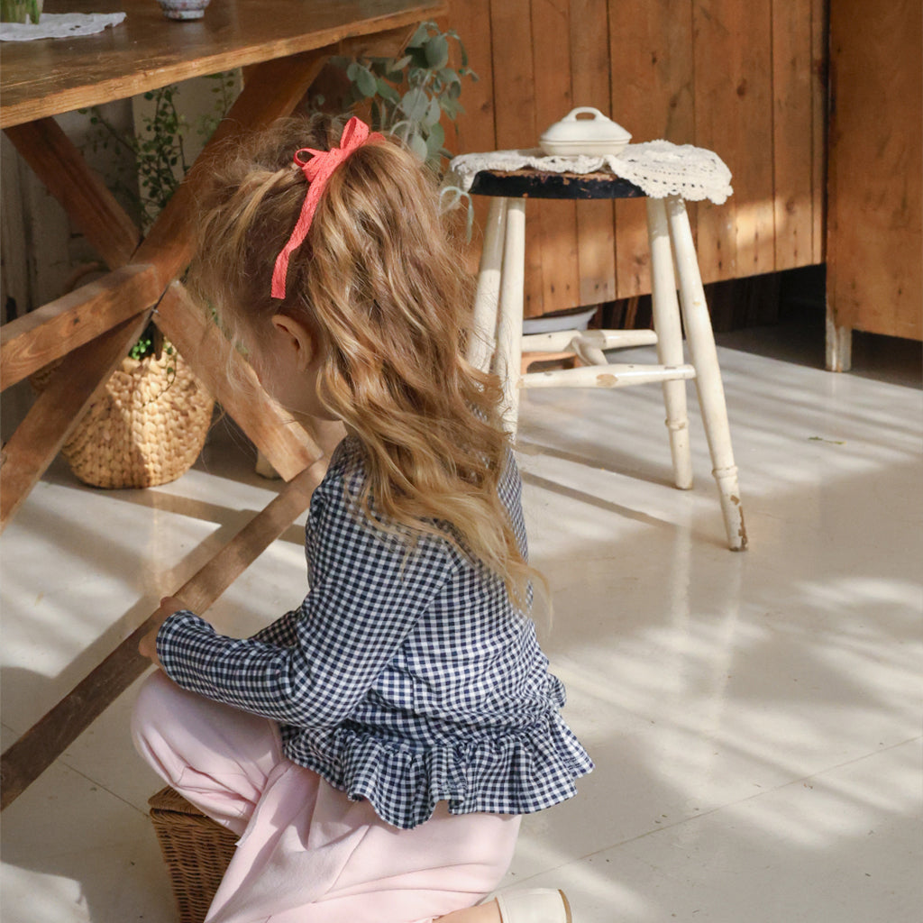 Child wearing Puella Flo Jen Floral Hair Pin in Red