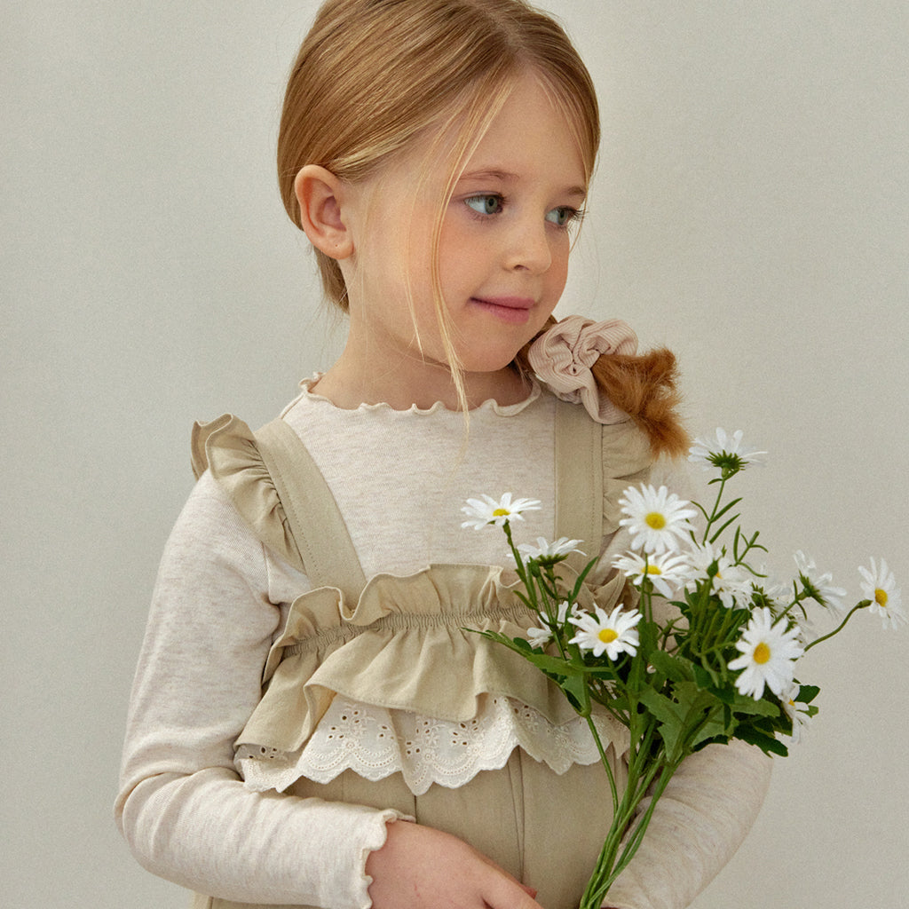 Child wearing ROA Lace Frill Overalls in Beige